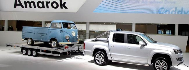 When towing a trailer, where should you place the weight of a load?