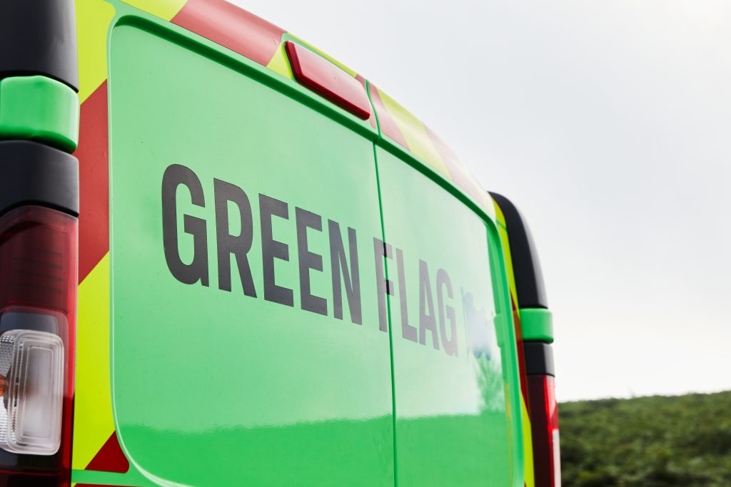 the letters 'GREEN FLAG' across the back of a green van