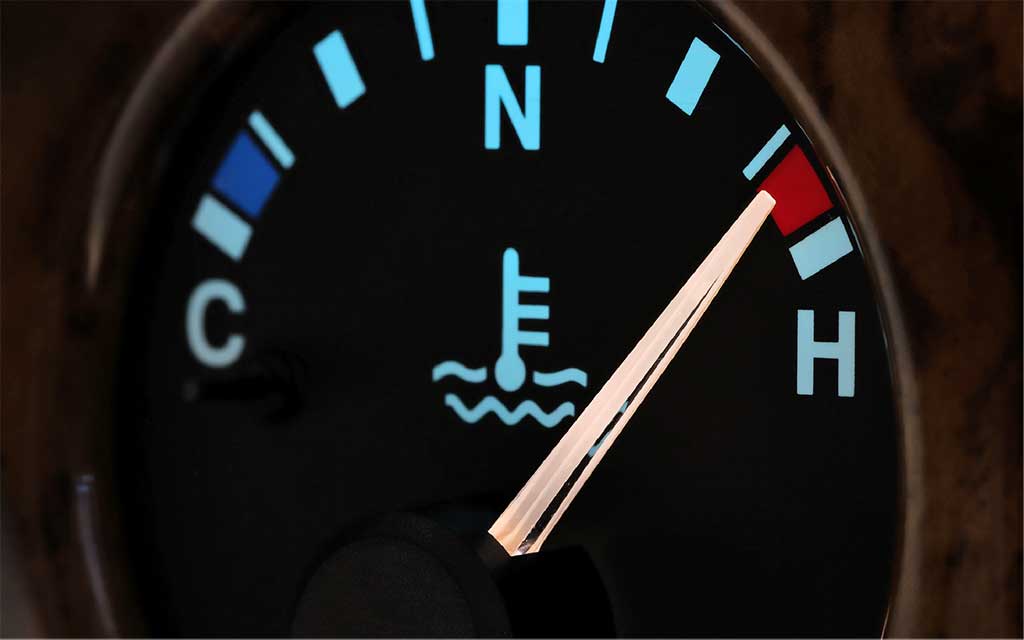 The temperature gauge on a car dashboard is showing the engine is too hot.