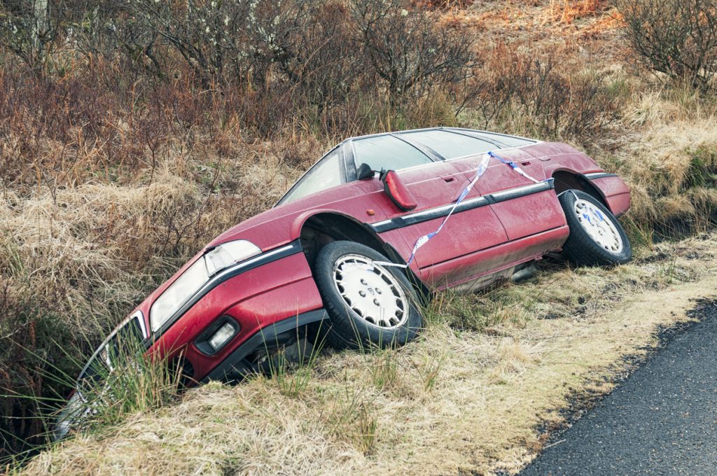 crashed-car-in-a-ditch-green-flag