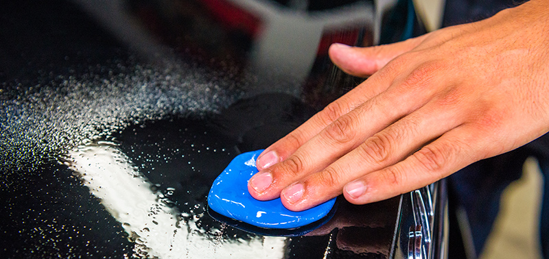 What is a clay bar used for when cleaning a car?